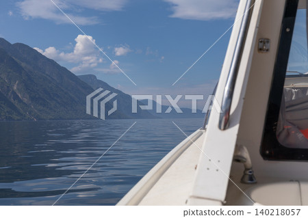 Boat view across Lake Teletskoye with Altai mountains and calm summer water Boat view across Lake Teletskoye with Altai mountains and calm summer water 140218057