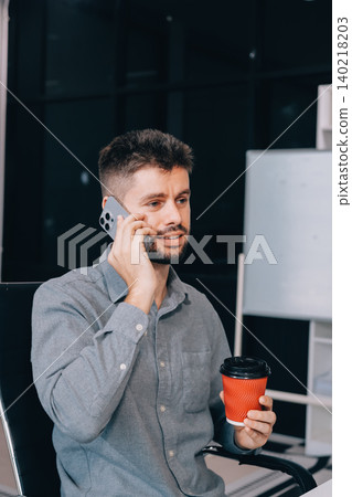 Tired worker. A tired businessman works in the evening. A man in office clothes is holding his temples. Problems in business. The businessman is trying to solve the problems that have arisen. 140218203
