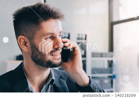 Tired worker. A tired businessman works in the evening. A man in office clothes is holding his temples. Problems in business. The businessman is trying to solve the problems that have arisen. 140218209