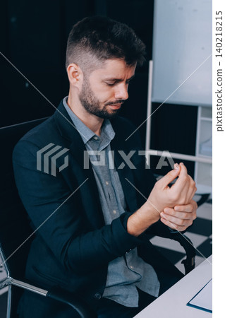 A man with a sore throat works inside the office, a businessman at work has a sore throat flu and cold, uses a laptop at work. A man with a sore throat works inside the office, a businessman at work has a sore throat flu and cold, uses a laptop at work. 140218215