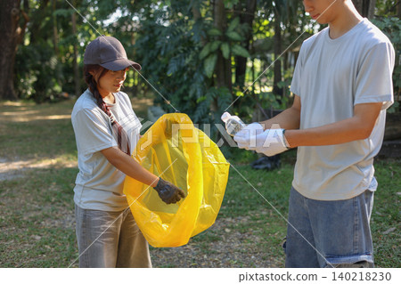 Young Volunteer Help Cleaning Public Park Collecting Garbages and Plastic Waste 140218230