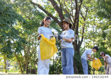 Group of Young Volunteer Help Cleaning Public Park Collecting Garbages and Plastic Waste Group of Young Volunteer Help Cleaning Public Park Collecting Garbages and Plastic Waste 140218244
