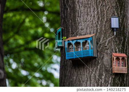 Miniature Traditional Wooden Balcony House Attached to Tree Trunk in Green Park Miniature Traditional Wooden Balcony House Attached to Tree Trunk in Green Park 140218275