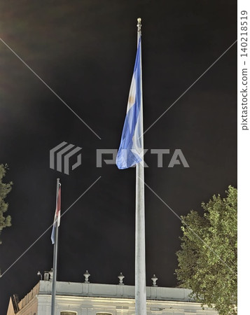 Cordoba, Argentina - April 10, 2026: Argentine flag illuminated above Plaza San Martin at night Cordoba, Argentina - April 10, 2026: Argentine flag illuminated above Plaza San Martin at night 140218519