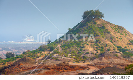Sir Bani Yas Island, United Arab Emirates - Jan 18 2024, aerial panoramic view of tree-covered mountain, in background, the MSC Virtuosa cruise ship is moored near the beach, Sir Bani Yas Island, UAE Sir Bani Yas Island, United Arab Emirates - Jan 18 2024, aerial panoramic view of tree-covered mountain, in background, the MSC Virtuosa cruise ship is moored near the beach, Sir Bani Yas Island, UAE 140219297