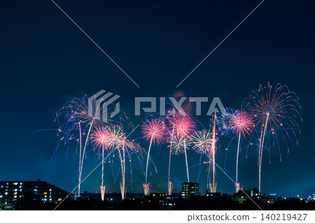 Colorful starbursts spread across the night sky Colorful starbursts spread across the night sky 140219427