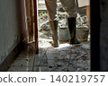 painter paints a wall with plaster trowel 140219757
