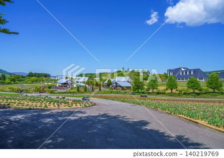 A tourist farm on a plateau with a clear blue sky and Scandinavian-style buildings. A tourist farm on a plateau with a clear blue sky and Scandinavian-style buildings. 140219769