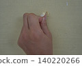 hand holding a pencil on a wooden board 140220266