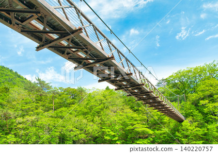 Nanatsuiwa Suspension Bridge, spanning the Hoki River in Shiobara Onsen, Nasushiobara City, Tochigi Prefecture. Nanatsuiwa Suspension Bridge, spanning the Hoki River in Shiobara Onsen, Nasushiobara City, Tochigi Prefecture. 140220757