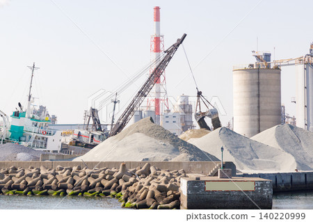 A hopper unloading crushed stone at a construction materials yard (ship number, name, and sign/logo have been corrected). 140220999