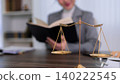 professional lawyer reading law book at office desk with golden scales of justice legal consultation law firm attorney studying legal case research legal 140222545