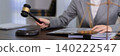 professional lawyer judge holding wooden gavel making decision courtroom legal ruling judgment process law office desk document case corporate business 140222547