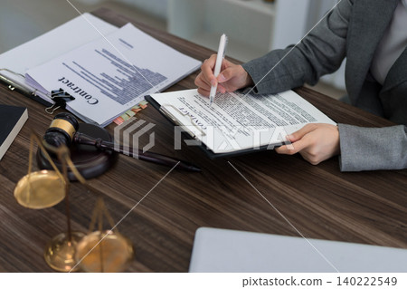 professional lawyer reviewing signing legal contract document with gavel on desk in law office workspace business agreement consultation legal services attorney professional lawyer reviewing signing legal contract document with gavel on desk in law office workspace business agreement consultation legal services attorney 140222549