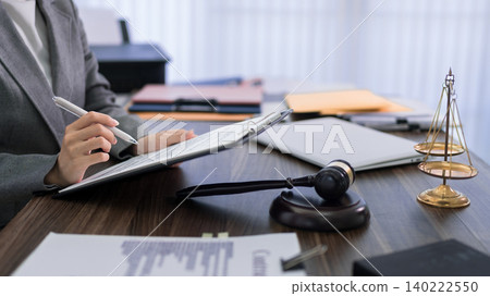 professional lawyer writing legal document at desk with gavel and justice scales in law office preparing court case consultation business meeting professional lawyer writing legal document at desk with gavel and justice scales in law office preparing court case consultation business meeting 140222550