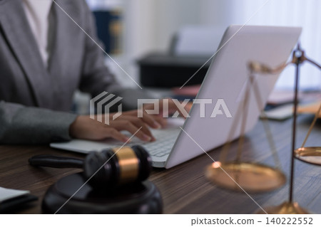 professional lawyer attorney working on laptop computer with gavel scale justice at office desk legal consultant researching case law preparing court document professional lawyer attorney working on laptop computer with gavel scale justice at office desk legal consultant researching case law preparing court document 140222552