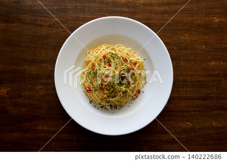 Spaghetti Aglio e Olio with a table background viewed from directly above. Spaghetti Aglio e Olio with a table background viewed from directly above. 140222686