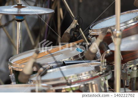Closeup of drum set microphone drumsticks prepared for live music performance rehearsal recording entertainment events 140222702