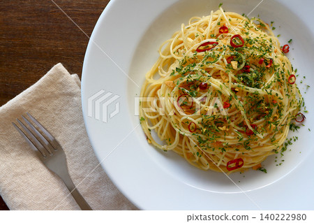 Spaghetti Aglio e Olio with a table background viewed from directly above. Spaghetti Aglio e Olio with a table background viewed from directly above. 140222980
