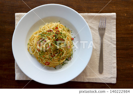 Spaghetti Aglio e Olio with a table background viewed from directly above. Spaghetti Aglio e Olio with a table background viewed from directly above. 140222984