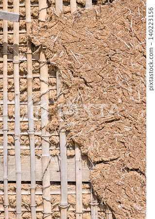 Earthen wall with exposed bamboo underlayment; underlayment structure Earthen wall with exposed bamboo underlayment; underlayment structure 140223156