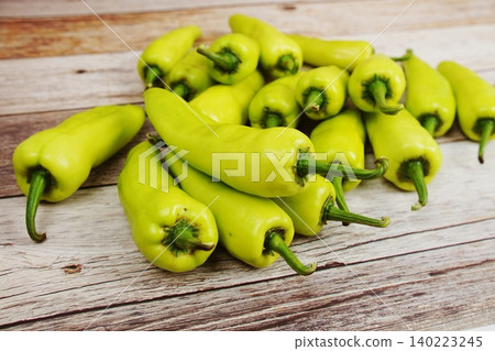 Fresh green bell pepper or capsicum on wooden background Fresh green bell pepper or capsicum on wooden background 140223245