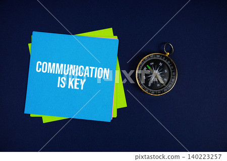 Communication Is Key text written on sticky note with compass on blue background Communication Is Key text written on sticky note with compass on blue background 140223257