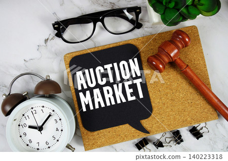 Auction Market text on speech bubble with alarm clock and wooden gavel on marble background Auction Market text on speech bubble with alarm clock and wooden gavel on marble background 140223318