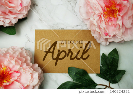 Welcome April text with pink flower on marble background Welcome April text with pink flower on marble background 140224231
