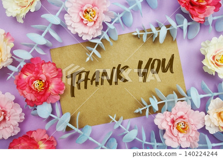 Thank You text written on paper card with flowers decoration Thank You text written on paper card with flowers decoration 140224244