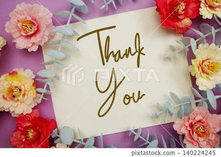 Thank You text written on paper card with flowers decoration Thank You text written on paper card with flowers decoration 140224245