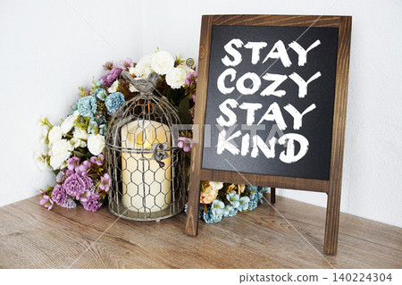 Stay Cozy, Stay Kind message written on easel blackboard Stay Cozy, Stay Kind message written on easel blackboard 140224304