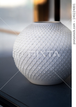 A display in front of the store at Benimura Kiln (a pottery studio with over 100 years of history) on Chawan-zaka Street, in front of Kiyomizu-dera Temple in Kyoto: a white porcelain vase. A display in front of the store at Benimura Kiln (a pottery studio with over 100 years of history) on Chawan-zaka Street, in front of Kiyomizu-dera Temple in Kyoto: a white porcelain vase. 140224801