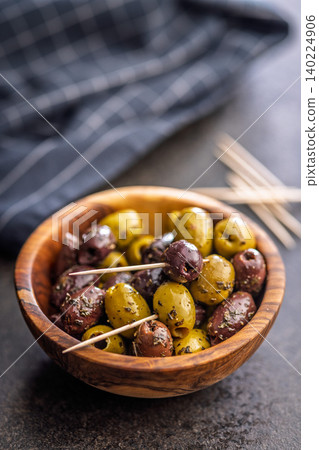 Marinated Mixed Olives in Wooden Bowl With Olive Oil and Toothpicks Mediterranean Appetizer Marinated Mixed Olives in Wooden Bowl With Olive Oil and Toothpicks Mediterranean Appetizer 140224906