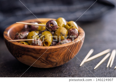 Marinated Mixed Olives in Wooden Bowl With Olive Oil and Toothpicks Mediterranean Appetizer 140224907