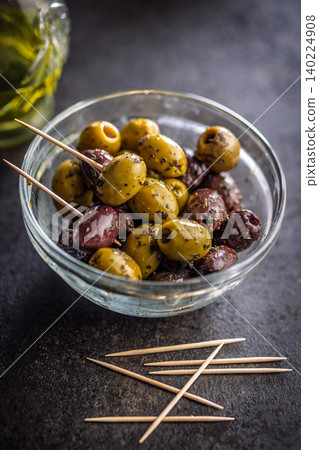 Marinated Green And Kalamata Olives In Glass Bowl With Olive Oil And Toothpicks Marinated Green And Kalamata Olives In Glass Bowl With Olive Oil And Toothpicks 140224908