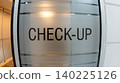 Close-up of a check-up text sign on a frosted glass door in a modern, clean medical clinic or hospital interior. Healthcare, wellness, and medical examination concept. 140225126