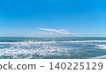 Wide sea horizon with blue water and white breaking waves under a clear sky with a large white cloud. Minimalist coastal landscape in Dalaman, Turkey. 140225129
