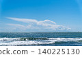Wide sea horizon with blue water and white breaking waves under a clear sky with a large white cloud. Minimalist coastal landscape in Dalaman, Turkey. 140225130