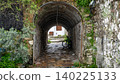 A stone archway tunnel in Marmaris old town alleyway with a bicycle parked inside. Historical Turkish urban exploration scene 140225133
