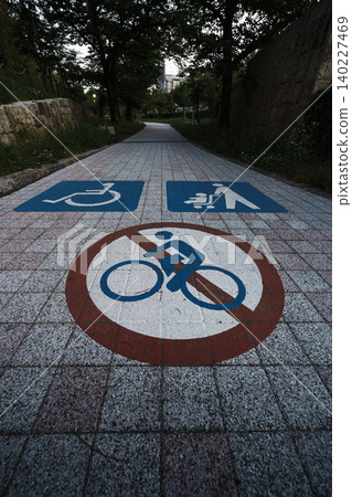 Road markings painted on cobblestone sidewalks in Japan: No bicycles, no wheelchairs, no strollers. Road markings painted on cobblestone sidewalks in Japan: No bicycles, no wheelchairs, no strollers. 140227469