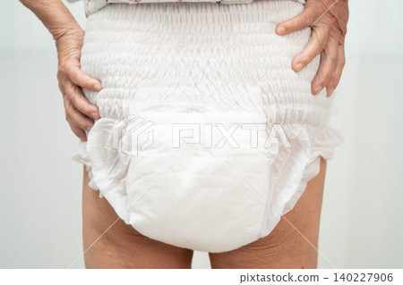 Asian senior woman patient wearing adult incontinence diaper pad in hospital. Asian senior woman patient wearing adult incontinence diaper pad in hospital. 140227906