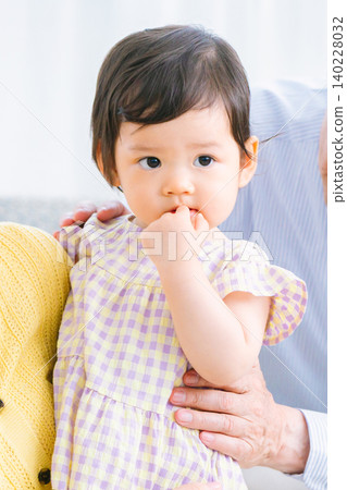 Children and family playing in the living room: infants, grandmother, grandfather 140228032