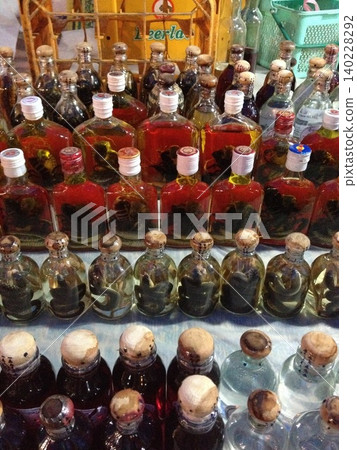 Bottles of snake wine and scorpion wine lined up in a Southeast Asian market. 140228292