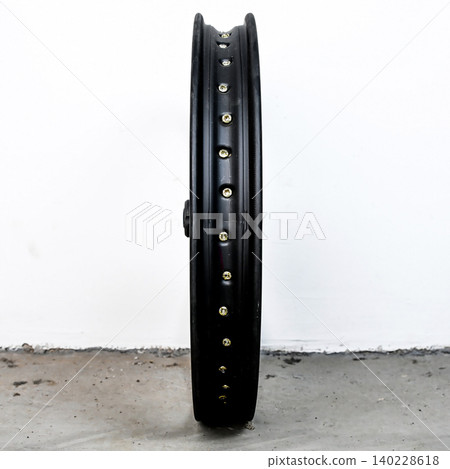 Black motorcycle wheel rim side view isolated on white background with silver spoke nipple and metal hub for motorbike custom tuning and repair part Black motorcycle wheel rim side view isolated on white background with silver spoke nipple and metal hub for motorbike custom tuning and repair part 140228618