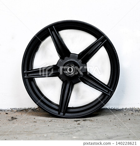 Black motorcycle wheel rim cast alloy five spoke design with metal hub isolated on white background for motorbike custom tuning and spare repair part 140228621