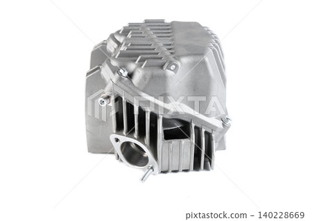 Motorcycle engine aluminum cylinder head assembly with valve cover isolated on white. Motorcycle engine aluminum cylinder head assembly with valve cover isolated on white. 140228669