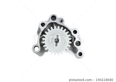 Motorcycle engine oil pump assembly with plastic drive gear isolated on white top view. Motorcycle engine oil pump assembly with plastic drive gear isolated on white top view. 140228680