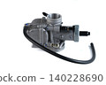 Motorcycle engine aluminum carburetor assembly with fuel rubber hose on white. 140228690