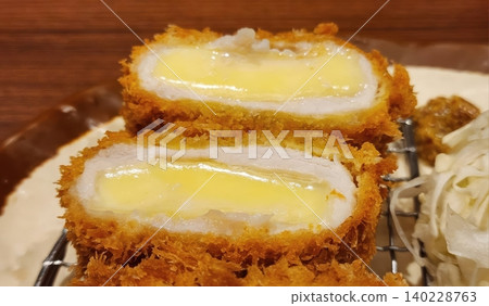 Golden Brown Crispy Fried Pork Cutlet filled with Gooey Melted Cheese 140228763
